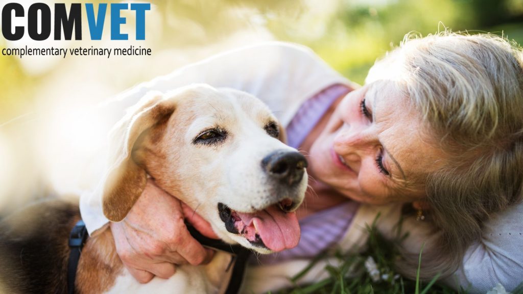 Lady and dog cuddling in advertising pose for dog supplements
